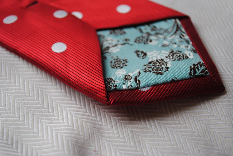 red and white polka spot tie with floral design to the rear by Frederick Thomas FT220