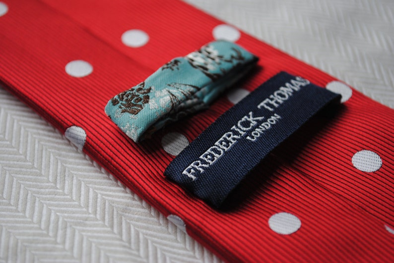 red and white polka spot tie with floral design to the rear by Frederick Thomas FT220